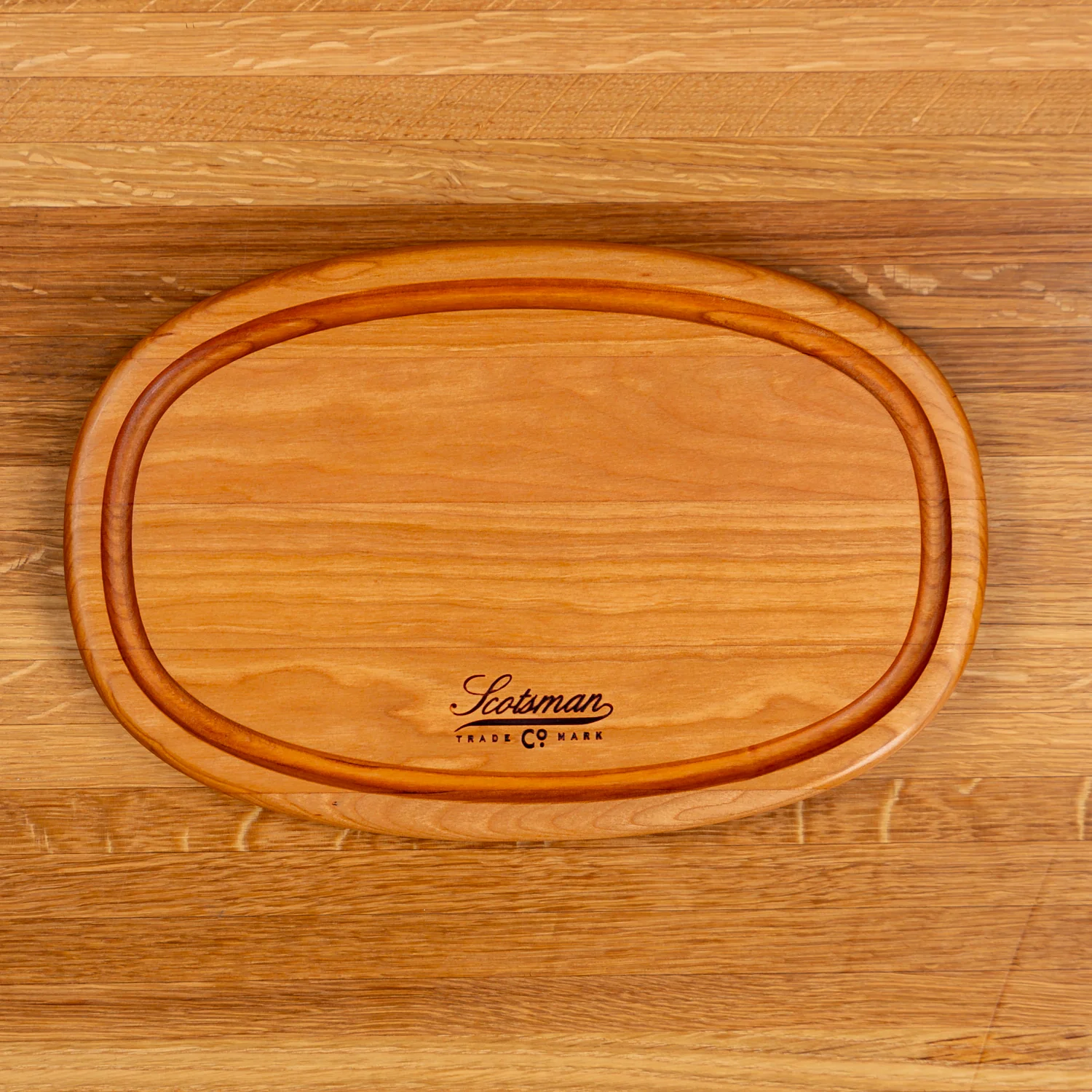 508-cherry-oval-serving-board-with-juice-groove-1.webp